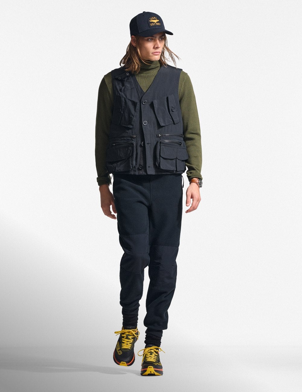 Man wears green parka over green quilted jacket and fleece.