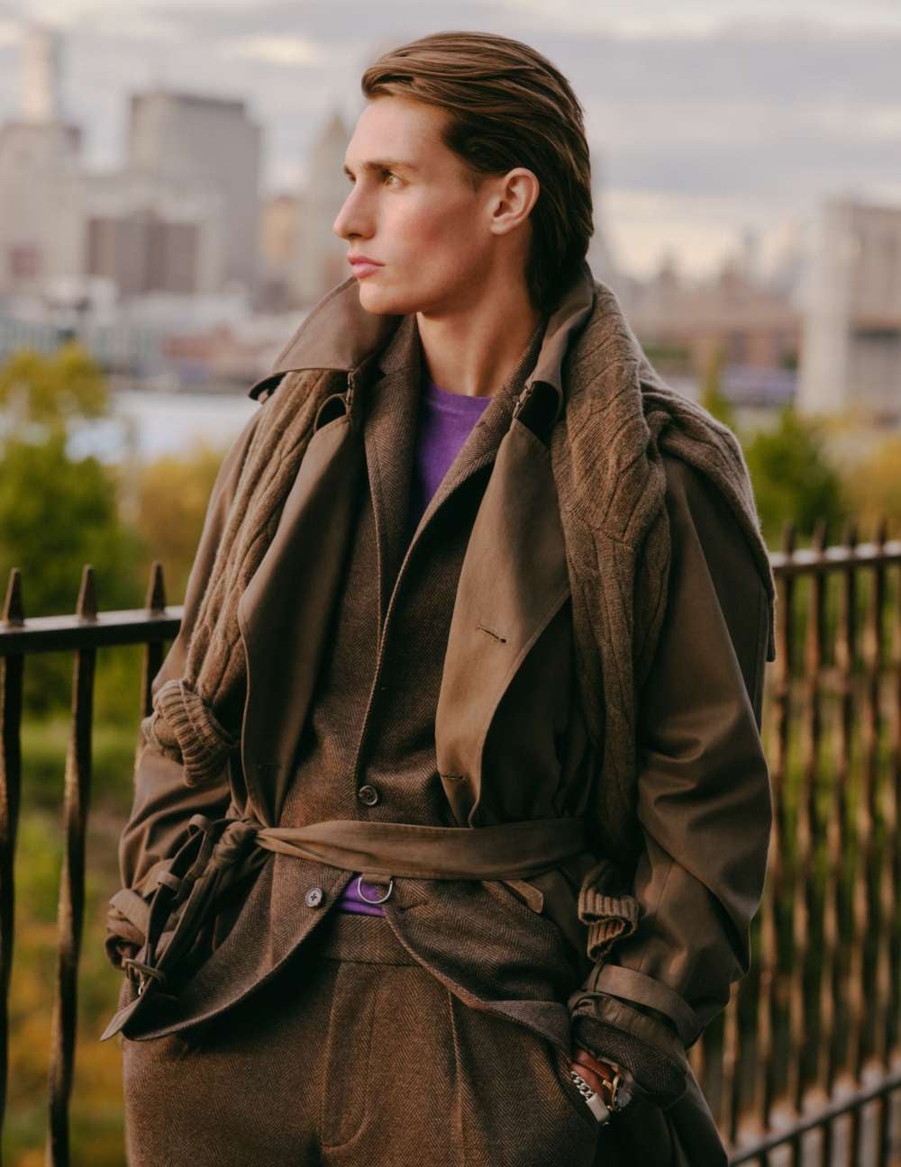 Man wears olive green suit over purple button-down.