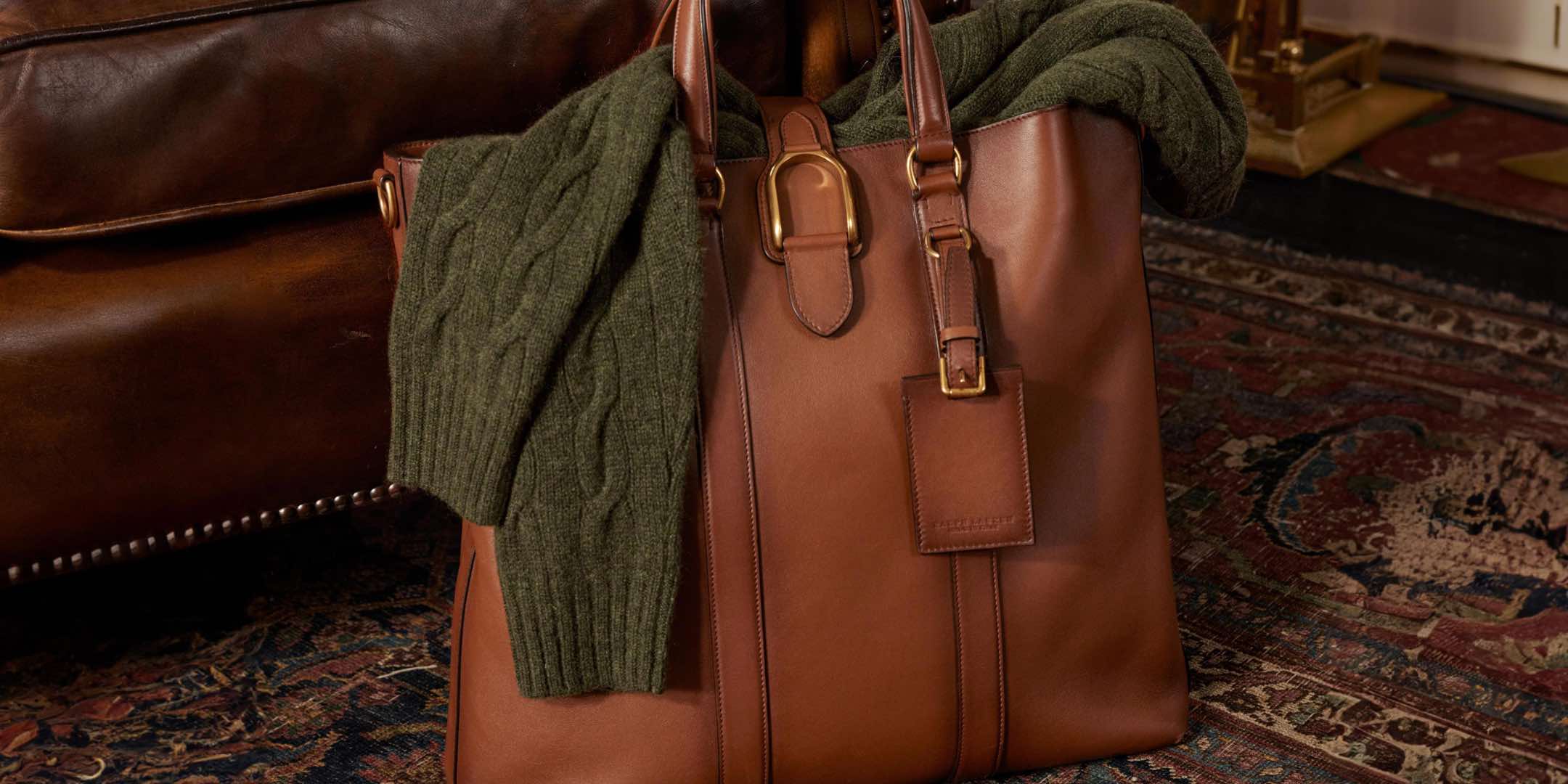 Olive cable knit on brown leather tote bag.
